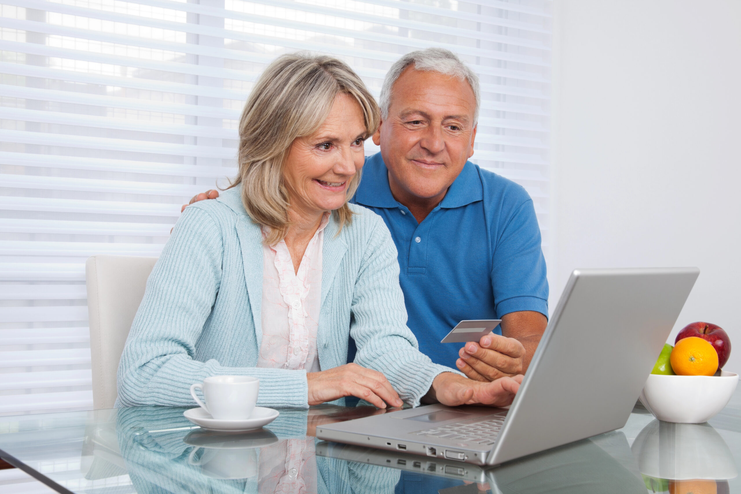 Woman sitting at a table doing a telehealth video with her doctor