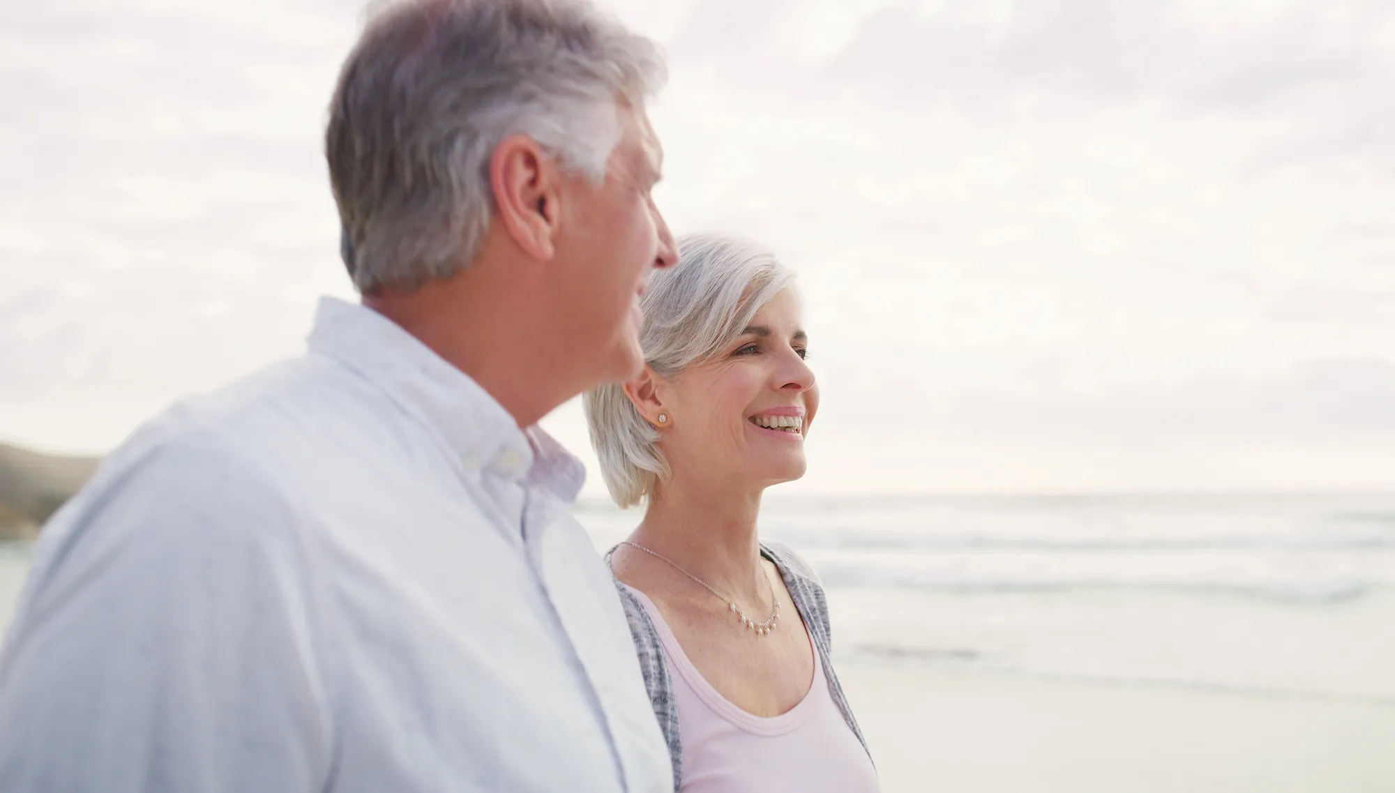 Couple looking Woman sitting at a table doing a telehealth video with her doctor